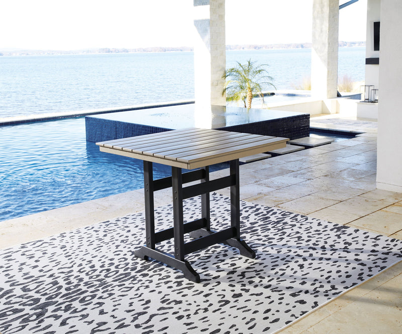 Counter-height dining table with driftwood slat top and black base