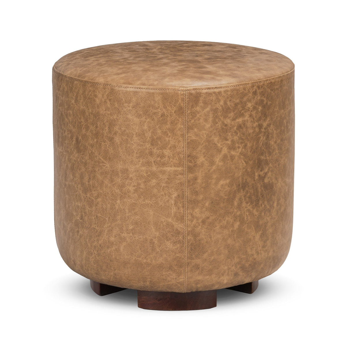 Round brown ottoman with textured top and dark wood legs