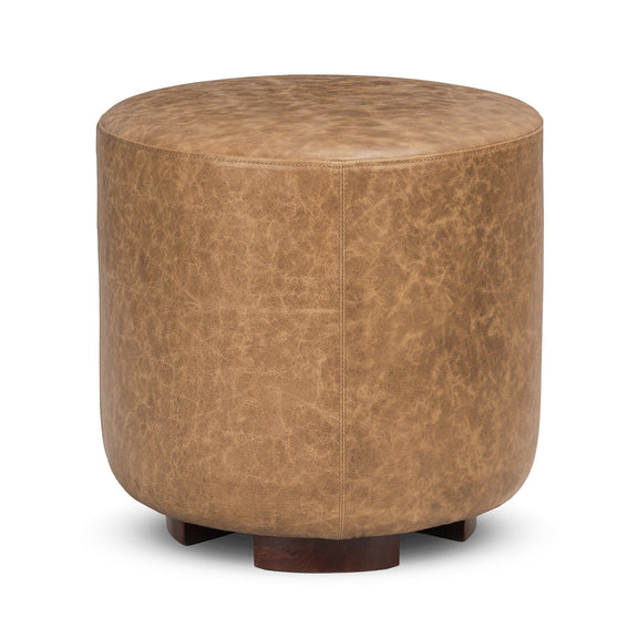 Round brown ottoman with textured top and dark wood legs