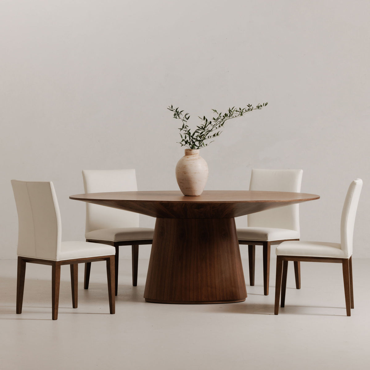 Natural walnut oval dining table with tapered pedestal base