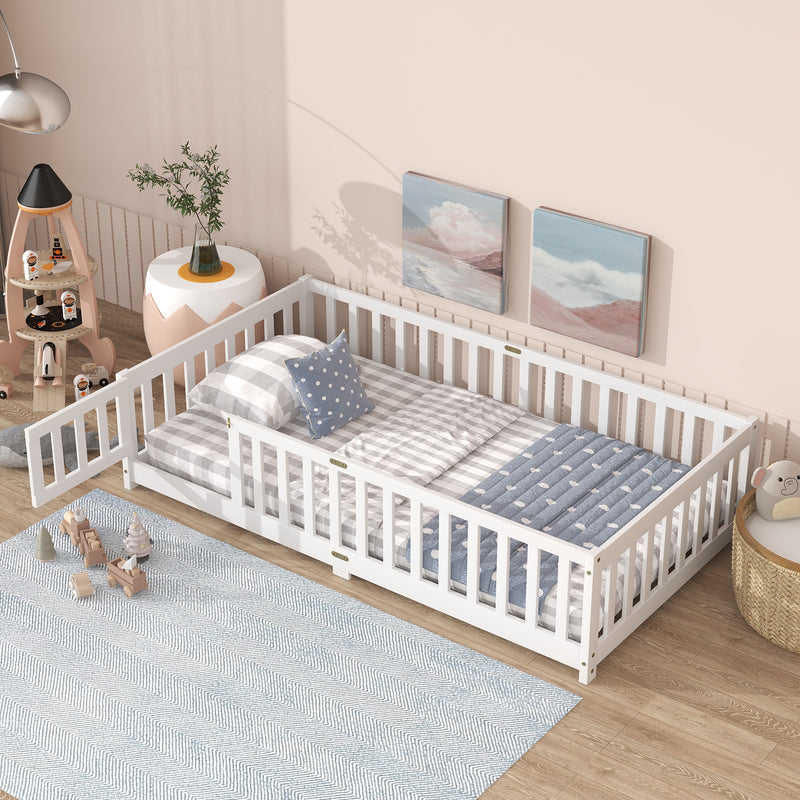 Twin size floor bed with white safety guardrails and fence style sides