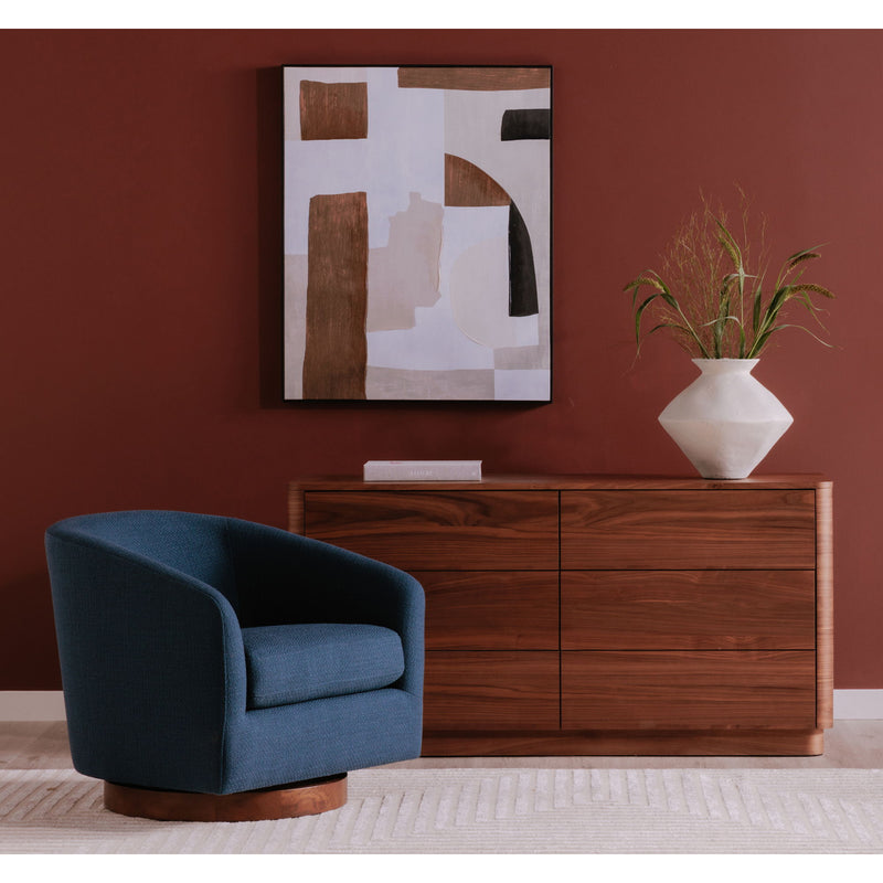 Blue swivel chair with rounded arms and low profile, shown in a living room