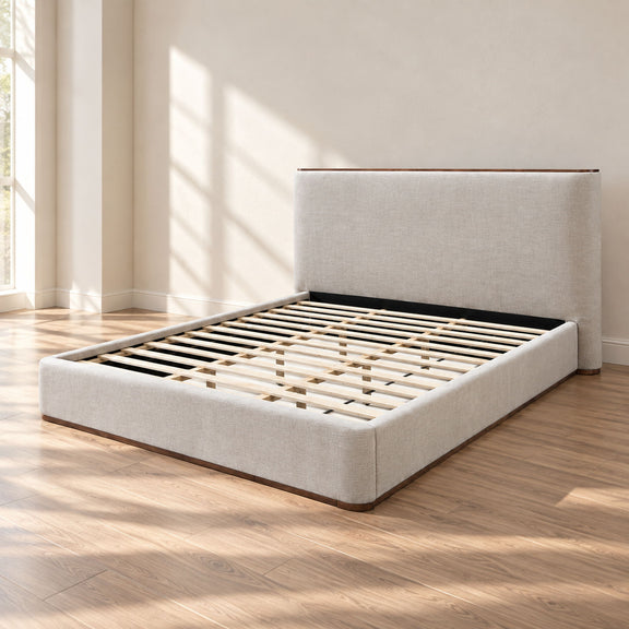 Light gray upholstered platform bed with slatted base and tall headboard