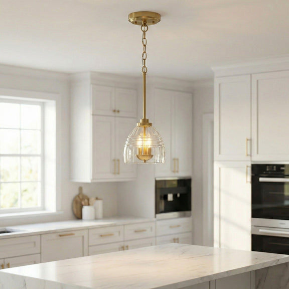 Gold chain pendant light with clear glass globe and three glowing candle-style bulbs