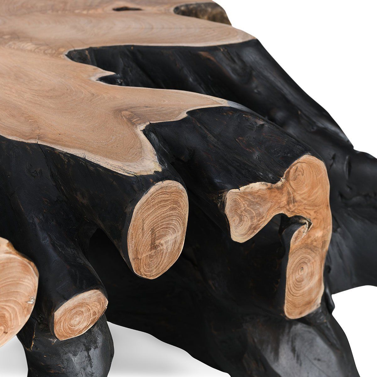 Black wood coffee table side detail with carved leg stumps and visible wood rings