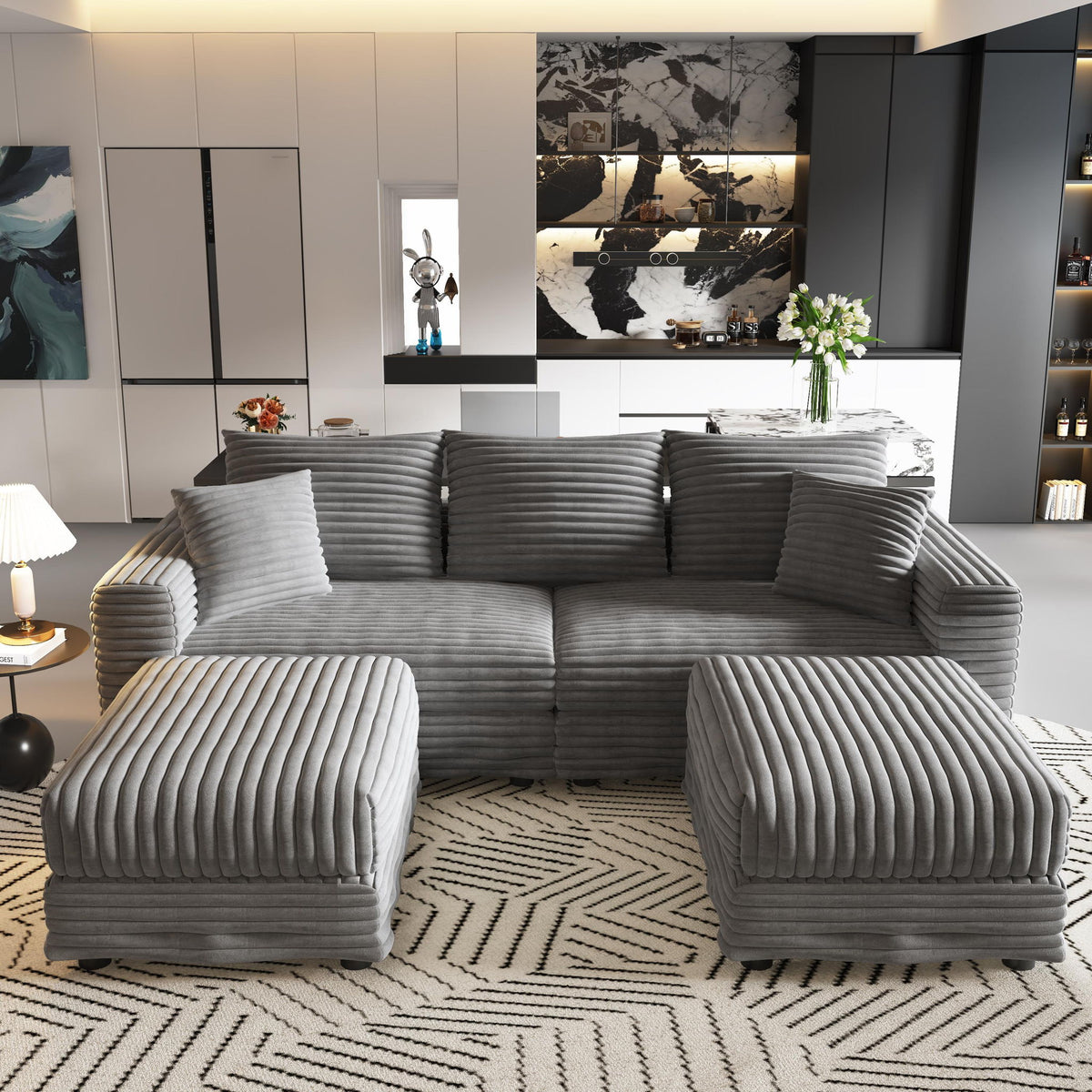 Dark gray sectional sofa with tufted back cushions and two padded ottomans