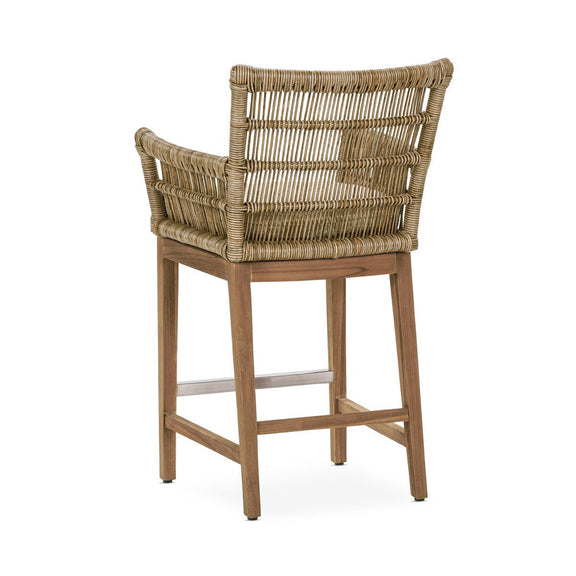 Natural woven counter stool with padded seat, curved backrest, and footrest