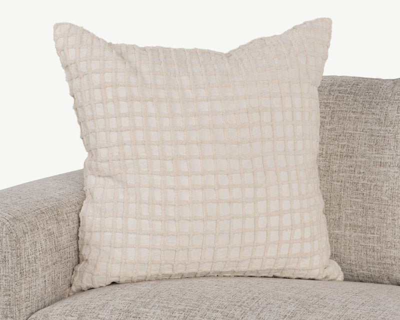 Ivory throw pillow with woven grid texture and subtle ruffled seam