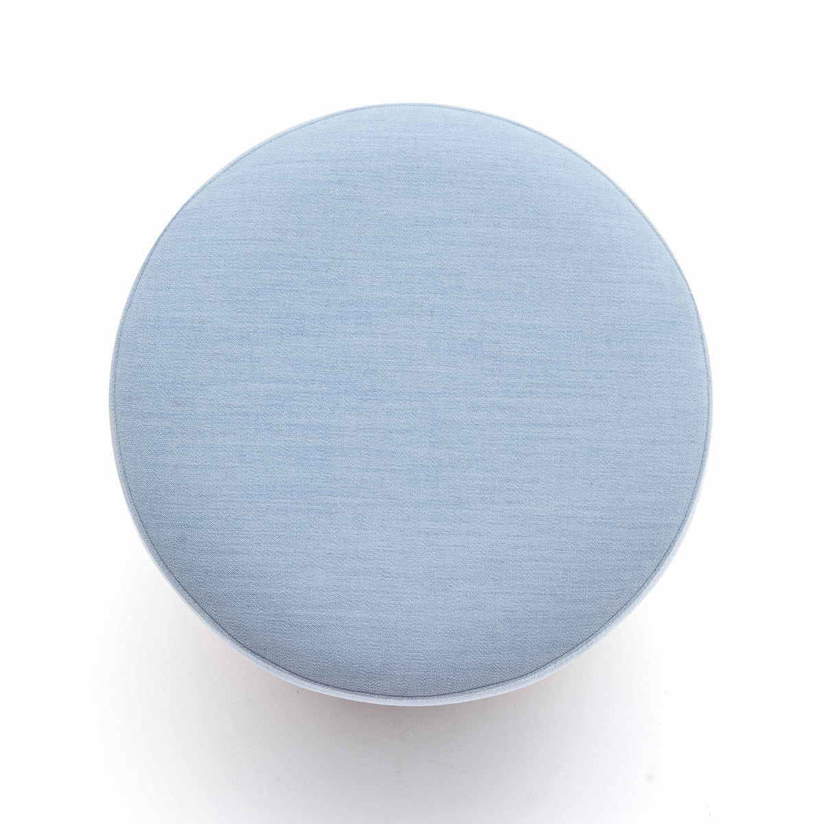 Light blue round ottoman top view, upholstered fabric surface