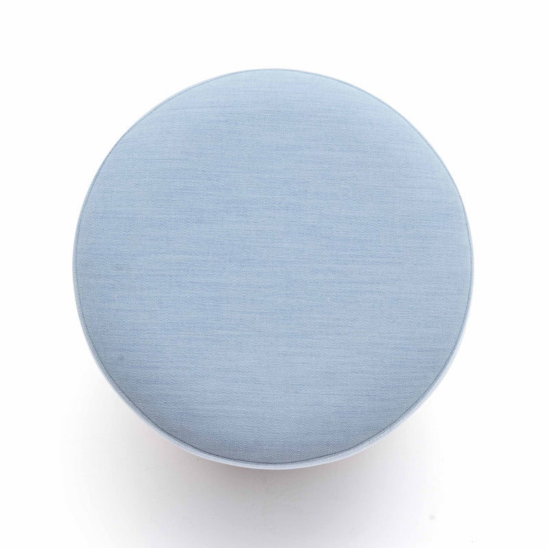 Light blue round ottoman top view, upholstered fabric surface