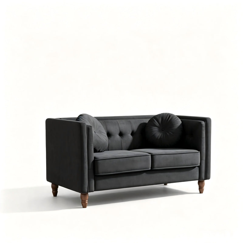 Black tufted two-seater loveseat with round bolster pillow and rolled arms