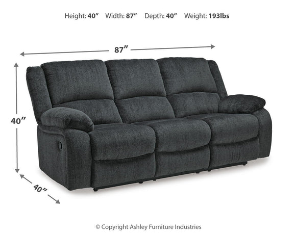 Dark gray reclining sofa with padded arms, three back cushions, 87 in width