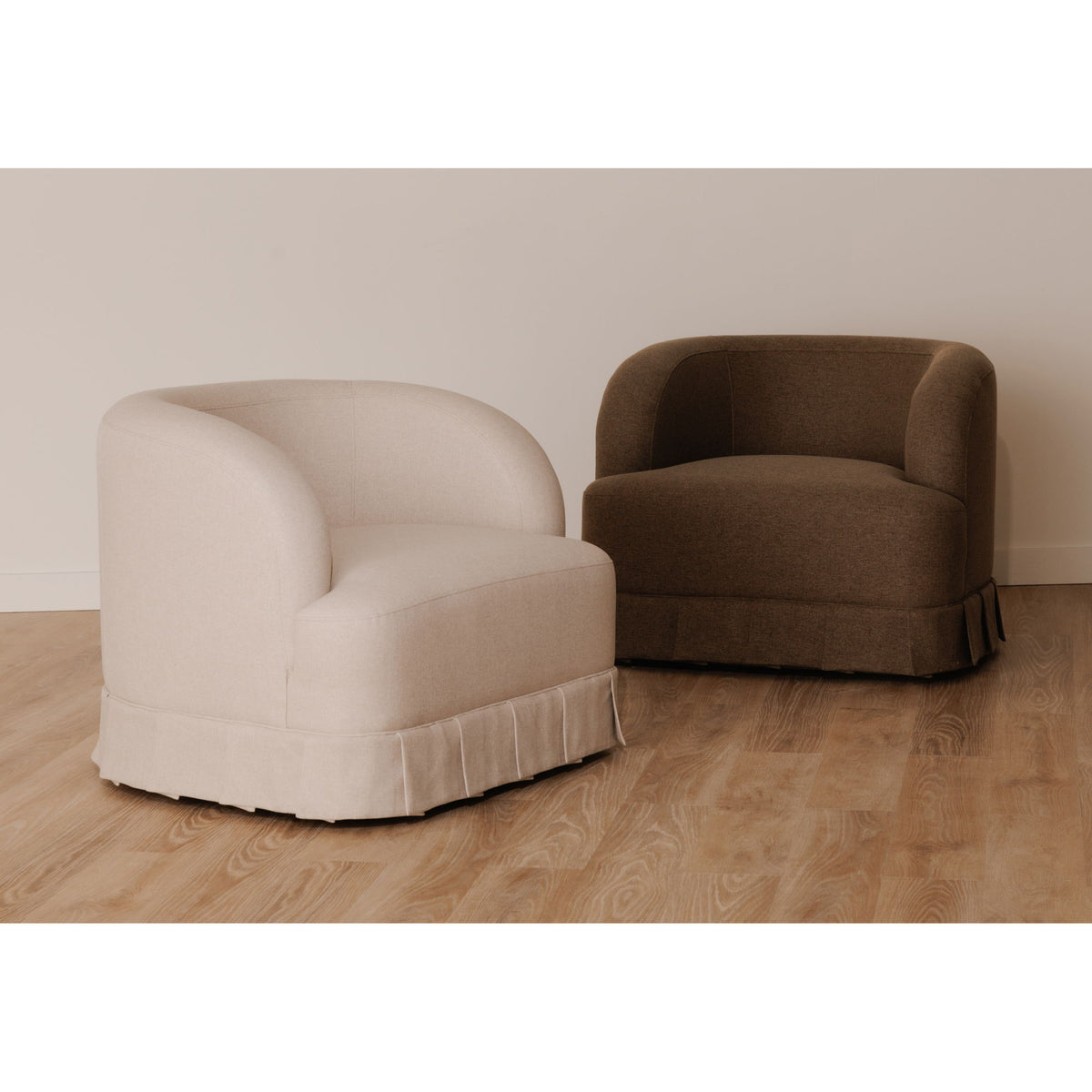 Dark brown swivel accent chair shown from side with rounded back and thick arms