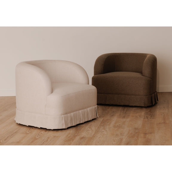 Dark brown swivel accent chair shown from side with rounded back and thick arms