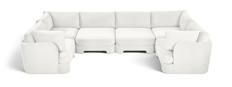 White velvet U-shaped sectional sofa with padded seats and matching armrests