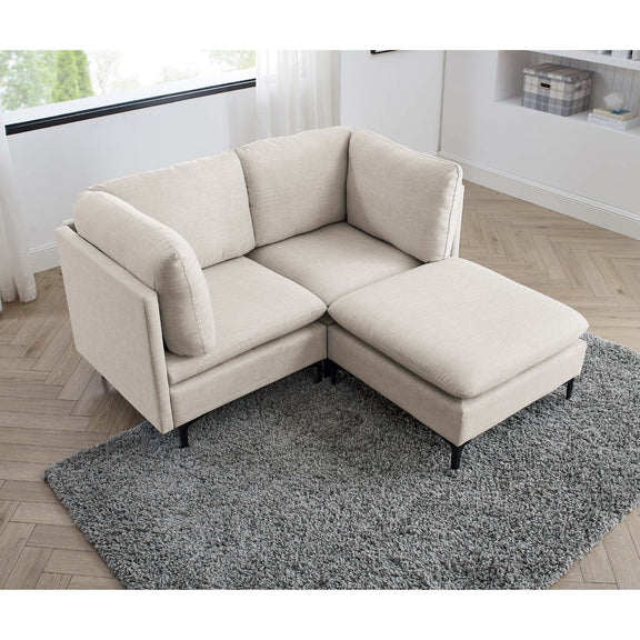 Beige upholstered sectional with tall legs, chaise ottoman, and corner seat cushion