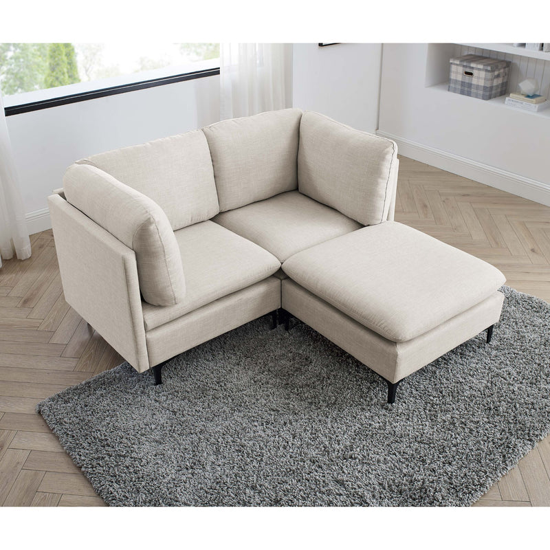 Beige upholstered sectional with tall legs, chaise ottoman, and corner seat cushion