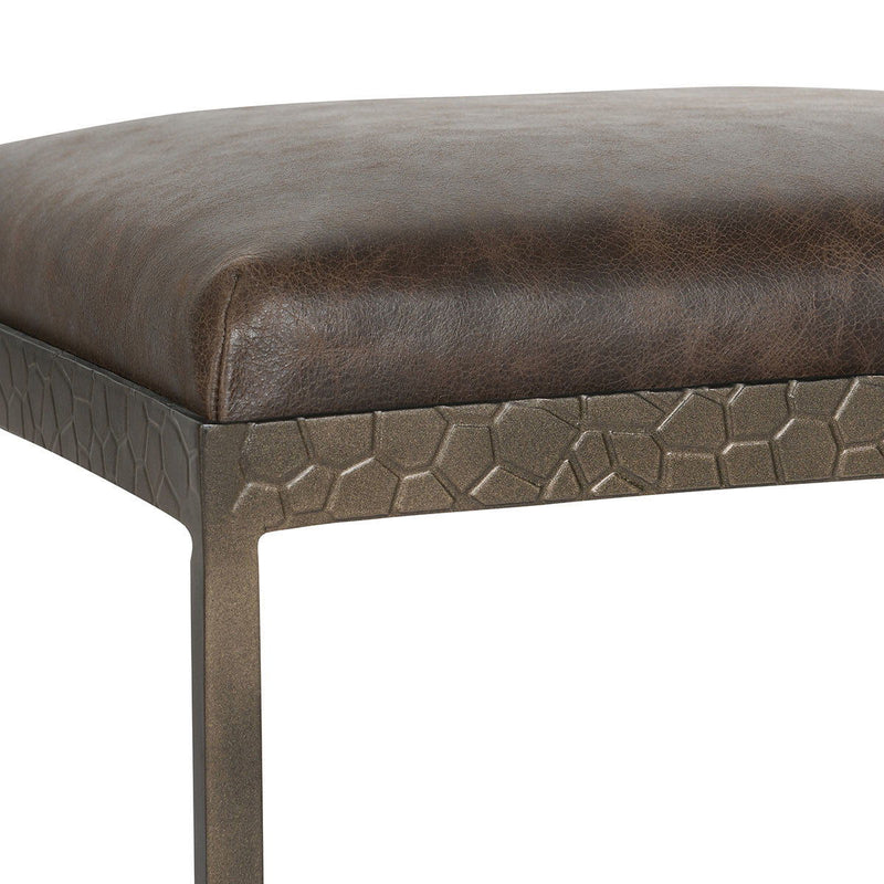 Brown leather corner detail with patterned band and sturdy metal stool frame