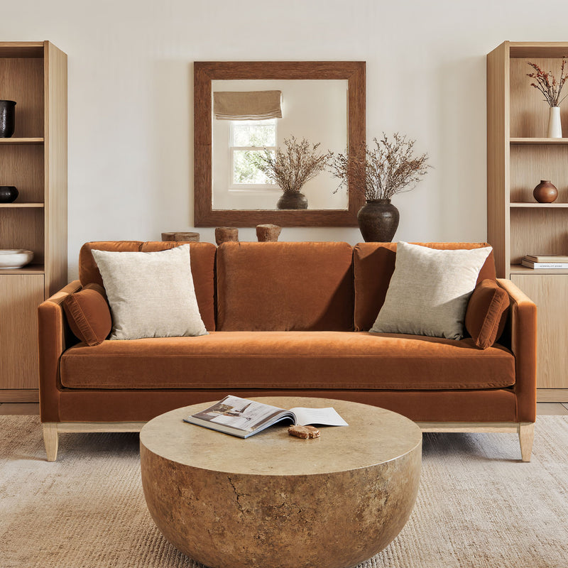 Brown modern farmhouse sofa with bolster pillows and square arms.