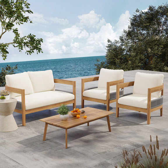 Outdoor loveseat with beige cushions and teak arms, with wooden coffee table and matching chairs