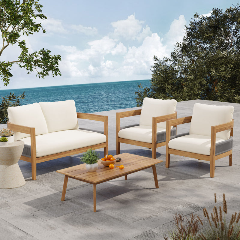 Outdoor loveseat with beige cushions and teak arms, with wooden coffee table and matching chairs