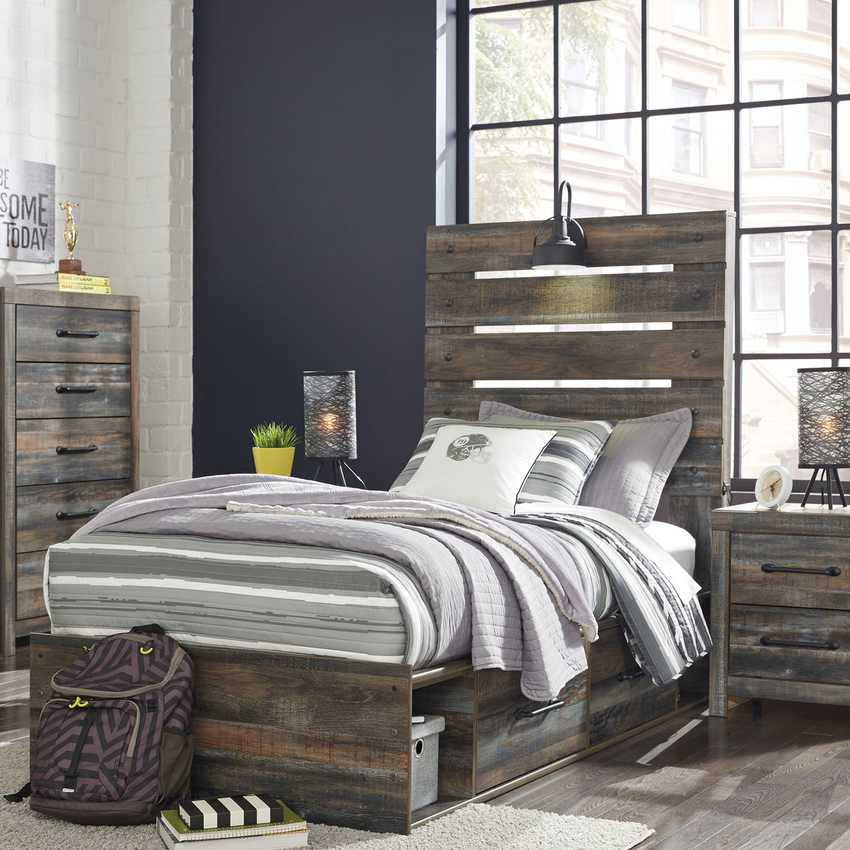 Drystan panel bed with dark wood headboard and two front drawers; striped comforter and pillows.