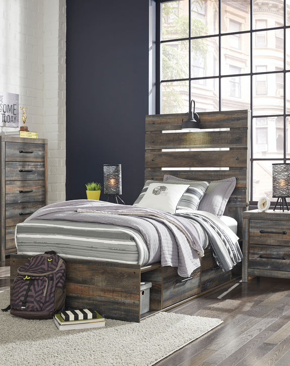 Drystan panel bed with dark wood headboard and two front drawers; striped comforter and pillows.