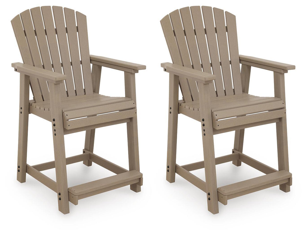 Two medium brown wooden barstools with slatted backrests and armrests