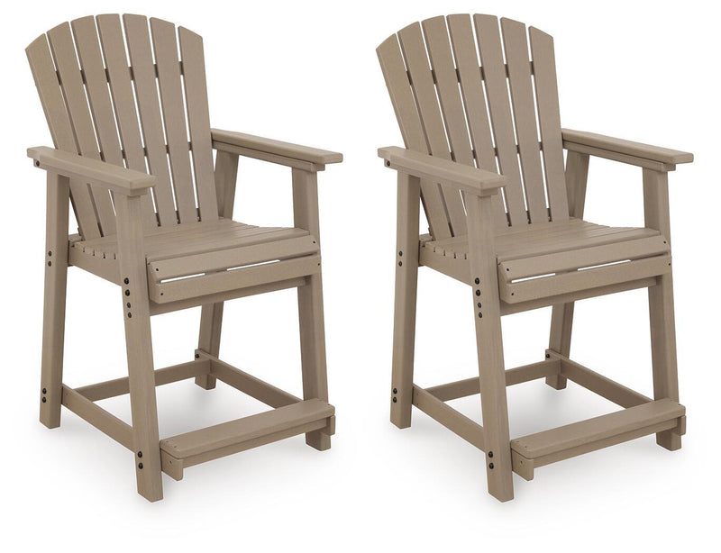 Two medium brown wooden barstools with slatted backrests and armrests