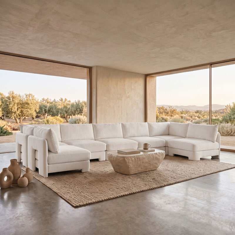 Beige velvet performance fabric U-shaped armless sectional with low back cushions.