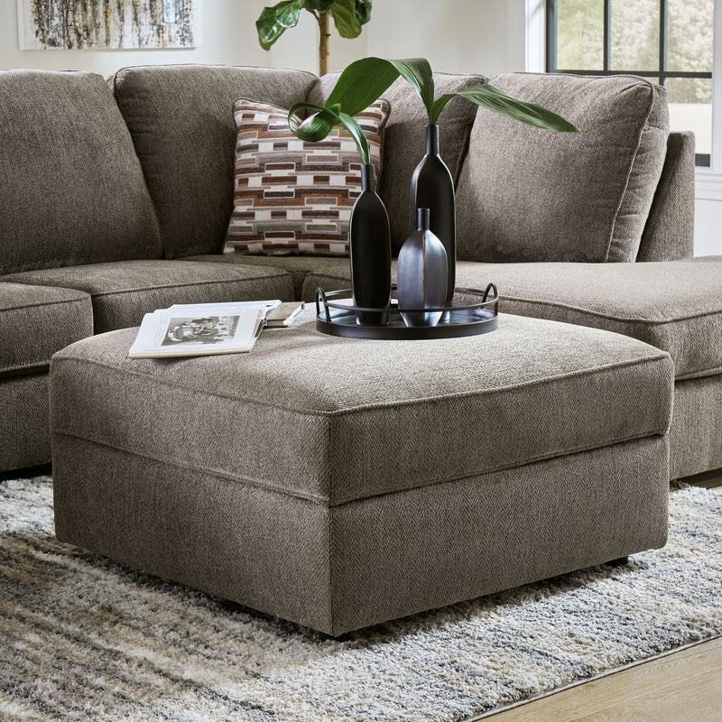 Putty upholstered storage ottoman with thick padded top