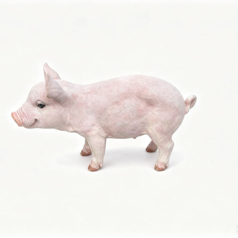 Baby pink pig garden statue figurine with lifelike details, standing side view.