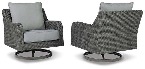 Pair of gray swivel lounge chairs with light cushions, textured wicker, round swivel bases