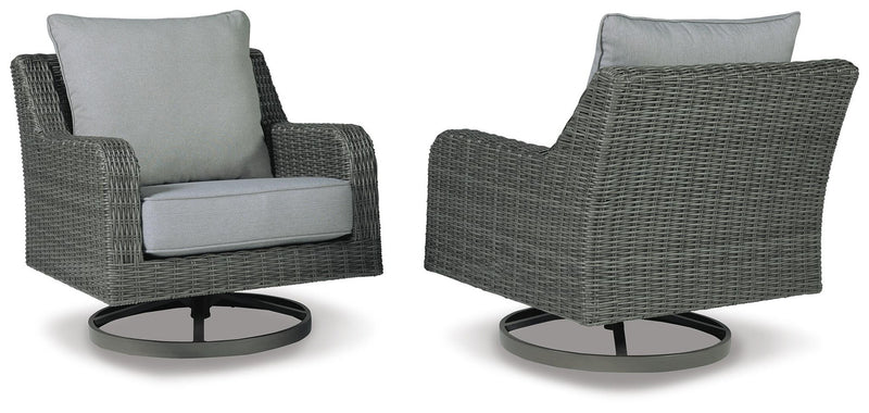 Pair of gray swivel lounge chairs with light cushions, textured wicker, round swivel bases