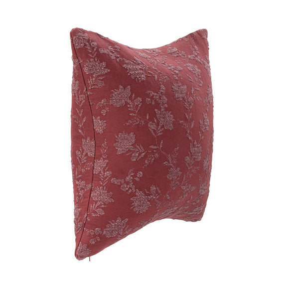 Burgundy red pillow with floral vine pattern, side view highlighting stitched edge.