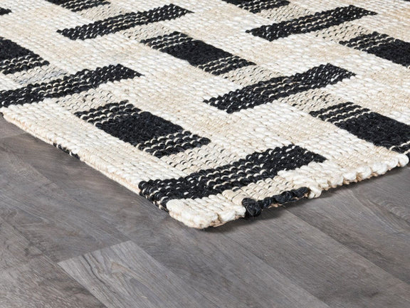 Ivory and black geometric rug with interlocking rectangular blocks, corner detail