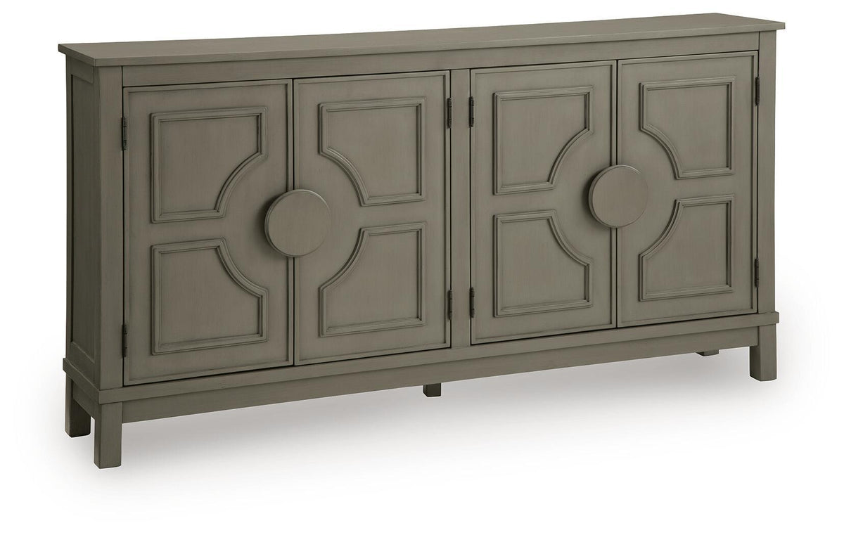 Warm gray accent cabinet with four panel doors and round center knobs