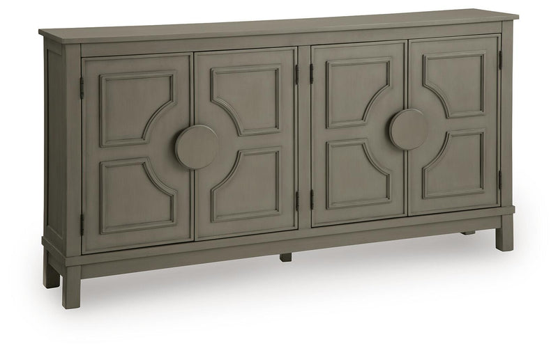 Warm gray accent cabinet with four panel doors and round center knobs