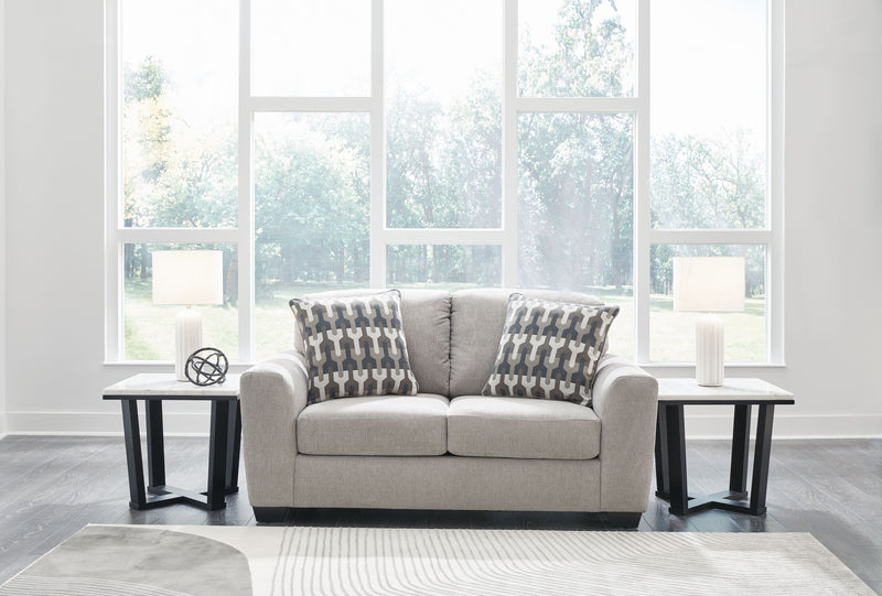 Gray flannel loveseat with two geometric throw pillows and two seat cushions