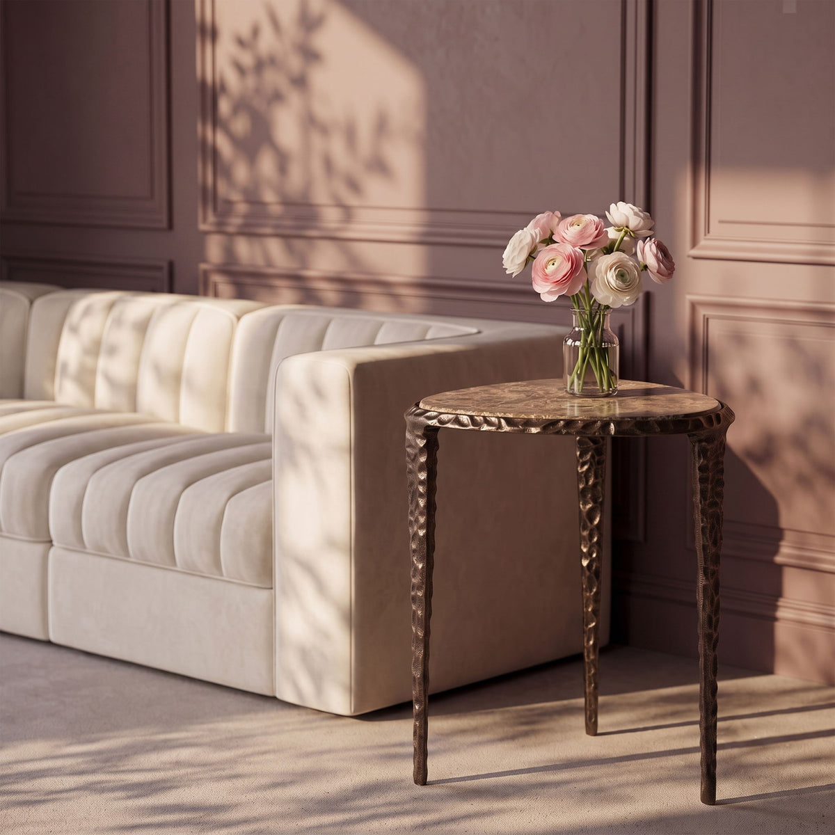 Round marble-top end table with dark metal legs, styled in a living room