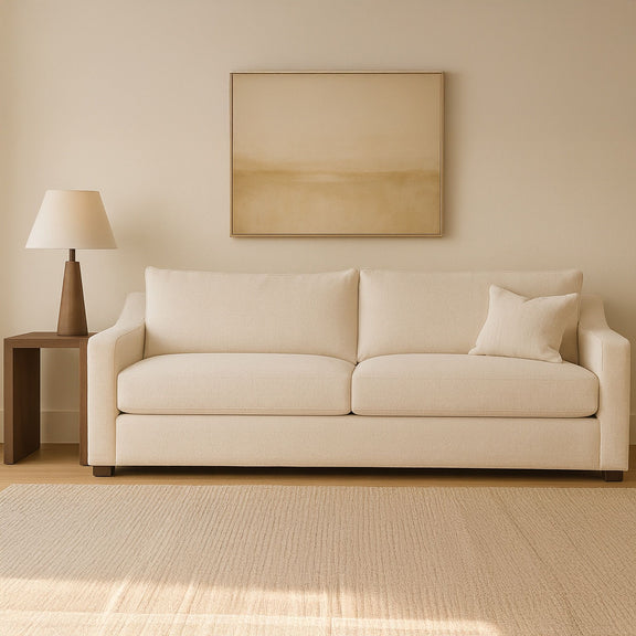 Light oat fabric sofa with two seat sections, back cushions, and block legs