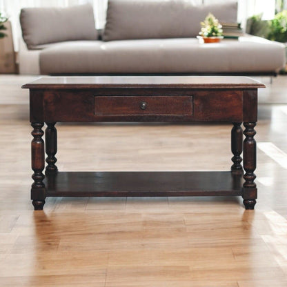 Dark brown console table with one drawer and turned legs, rectangular top and base shelf.