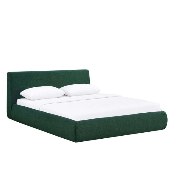 Dark green upholstered platform bed with tall headboard and white pillows