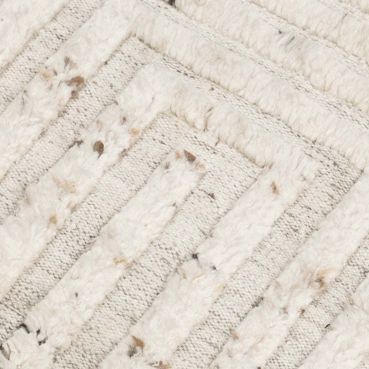 Ivory wool rug close-up showing textured diagonal stripes with speckled detailing