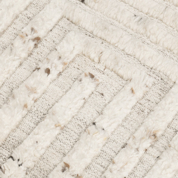 Ivory wool rug close-up showing textured diagonal stripes with speckled detailing