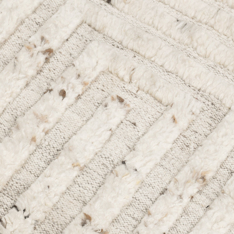 Ivory wool rug close-up showing textured diagonal stripes with speckled detailing