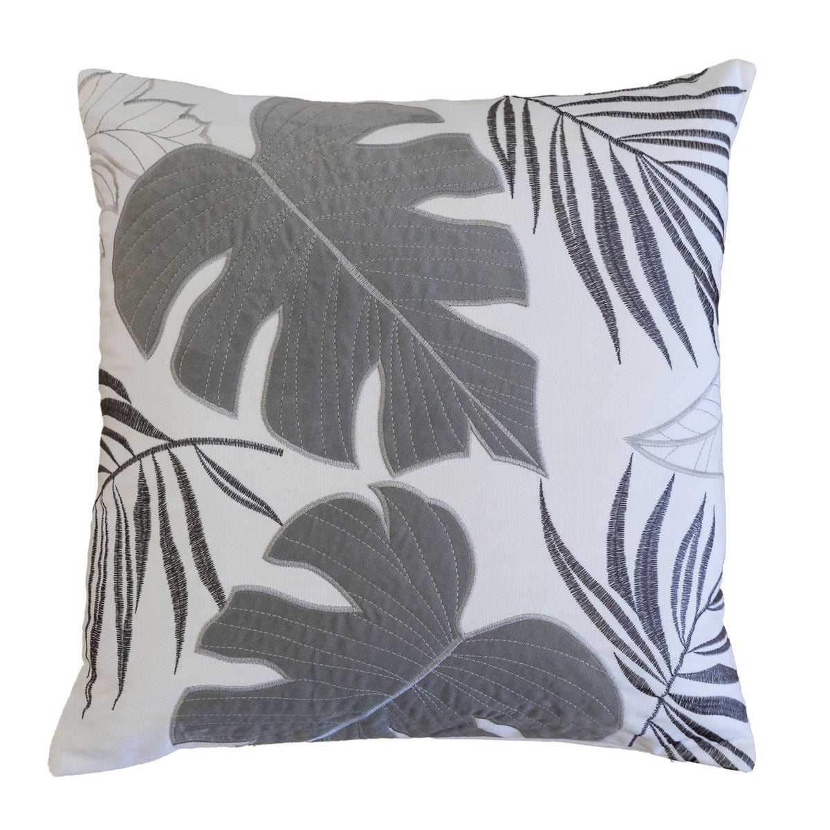 Leaf accent throw pillow with dark gray tropical leaves on white.