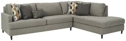 Gray sectional sofa with chaise, padded arms, and decorative throw pillows.