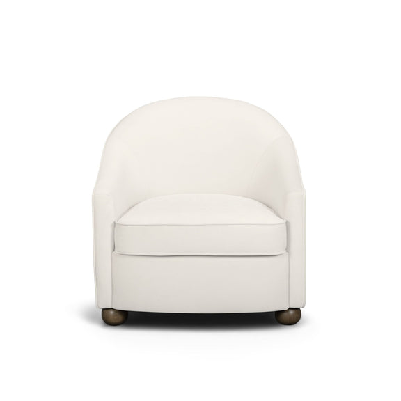 White performance velvet accent chair with rounded arms, boxy seat, and dark legs