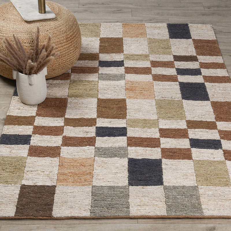 Natural checkered rug with multicolor textured squares in cream, tan, brown, gray, and navy